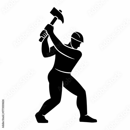 Construction worker swinging a sledgehammer with determination during a building project.