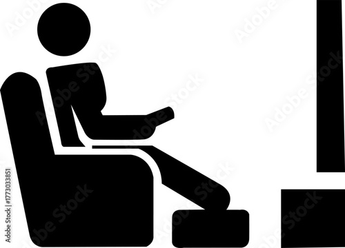 Person sitting in armchair holding remote watching television silhouette