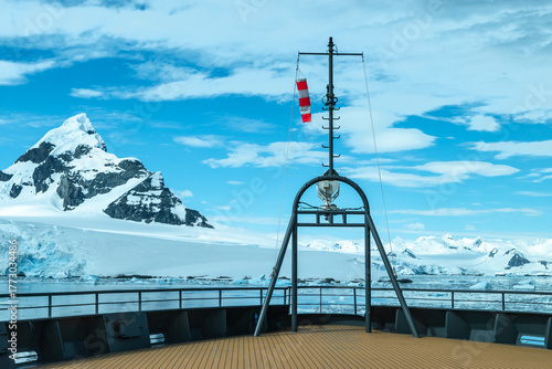 Cruise Ship Bow with Windsock in Front of Antarctic Mountains