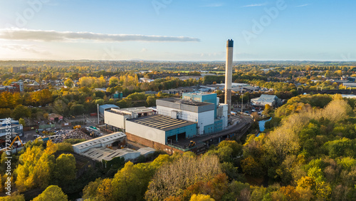Aerial view of an Energy from Waste generation plant with chimney and surrounding buildings, a factory converting non recyclable waste to energy
