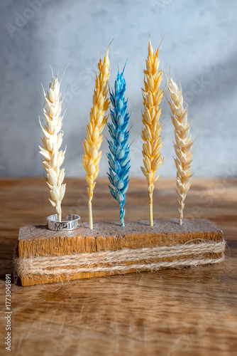 Wooden decor with colorful dried wheat and motivational inscription. Wheat decor. Symbol of Ukraine. Motivating inscription 