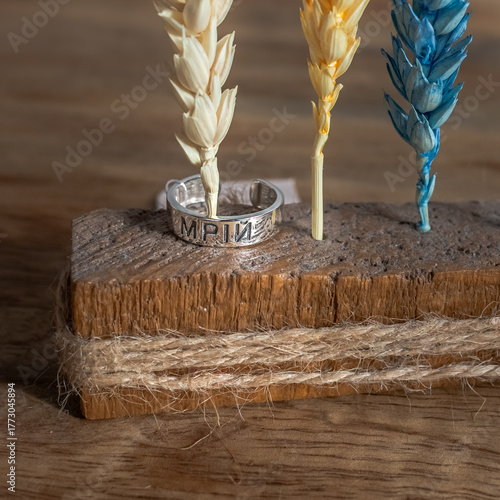 Wooden decor with colorful dried wheat and motivational inscription. Wheat decor. Symbol of Ukraine. Motivating inscription 