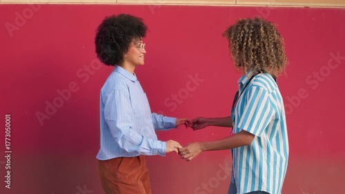 Friends dancing joyfully on a vibrant urban street