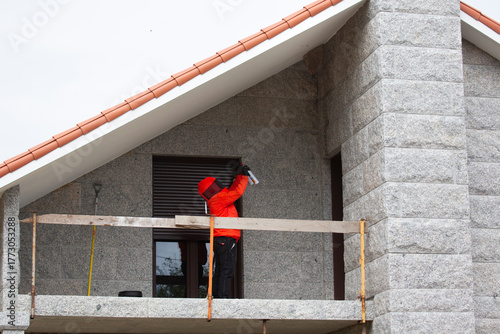 A pest control technician removes an Asian hornet (Vespa velutina) nest from a house under construction in Meis, Galicia.