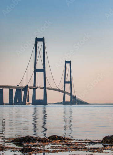 View of the Great Belt Suspension Bridge Reflected in Calm Sea Water at Sunset