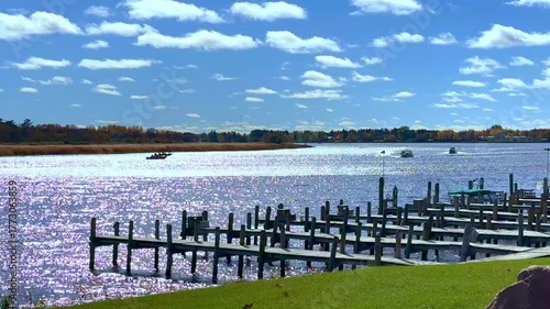 Wooden docks and a few fishing boats on the Rainy River which borders the United States and Canada, near Baudette, Minnesota on a sunny autumn morning.