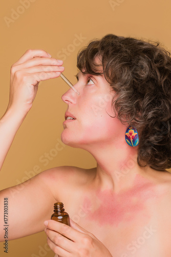 Woman applying serum accepting unique skin condition