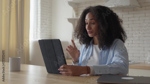 Video Call Conversation With Cheerful Woman At Bright Kitchen Table