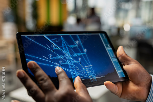 Photography Close up of engineer reviewing electrical grid data on tablet to identify energy audit findings and upgrade needs