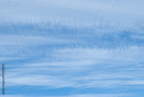 light, gentle clouds in a bright blue sky