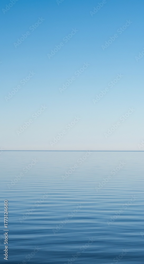 Obraz premium A vast expanse of tranquil water reflecting the sky, stretching endlessly towards the horizon, conveying calm and natural grandeur ,surface ,blue ,ripple