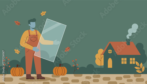Glazier holding large glass pane for home repairwindow installation during the cozy autumn season