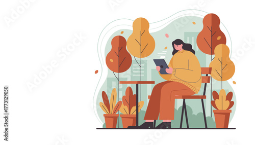 Woman using tablet outdoors in an autumn park Digital lifestyle remote work or online learning concept