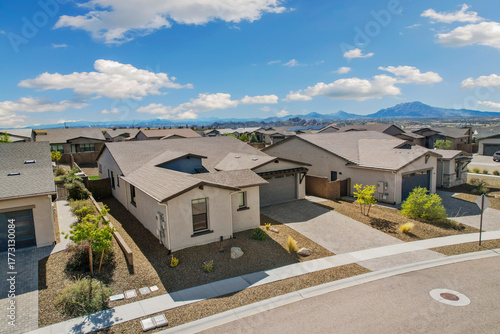 aerial perspective of current suburban house with desertthemed yard and scenic mountain background
