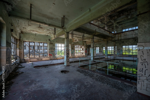 Abandoned distillery tower in Italy – circular industrial building with glass dome, steel beams, panoramic windows, decaying factory interior, urban exploration, post-industrial architecture
