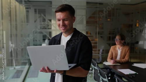 Man working on laptop in modern office space
