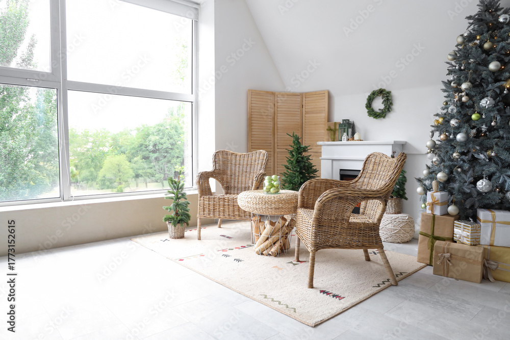 Fototapeta premium Interior of modern living room with fireplace decorated for Christmas