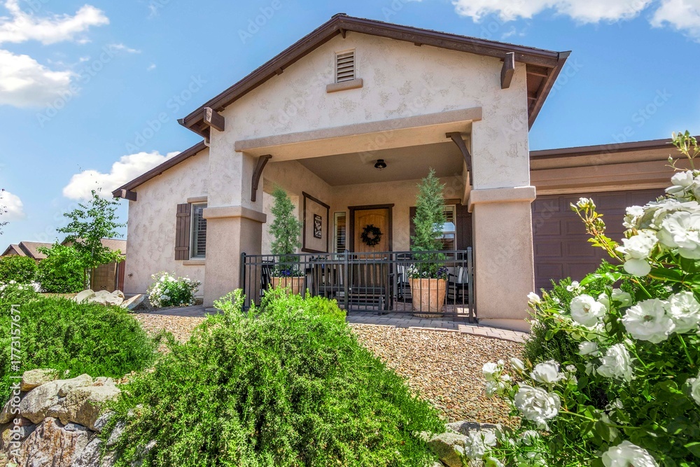 Fototapeta premium A lovely house with a charming porch and vibrant flowers 