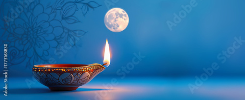 Oil lamp celebrating Kartik Purnima with full moon, blue background, traditional Indian festival, spiritual significance, vibrant illumination, intricate floral design, serene atmosphere