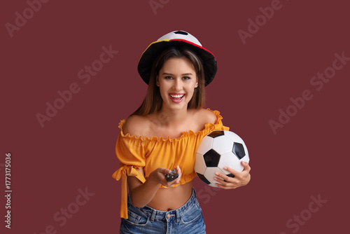 Young woman with TV remote ...