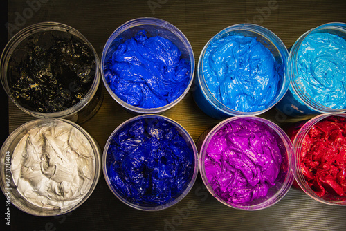 Creative Burst A Top View of Colorful Paint Jars. An artistic composition showcasing a rainbow of richly textured paints, symbolizing creativity, inspiration, and the endless possibilities of color.