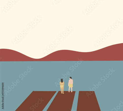 Couple wearing swimming suit and standing on wooden pier enjoying beautiful calm lake and mountain landscape view.