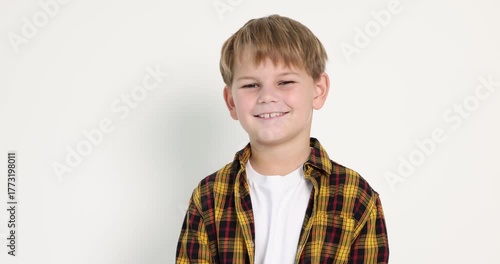 Happy little boy posing on white background