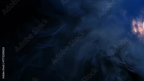 Mysterious Blue Smoke Swirling in the Dark with a Light Source.