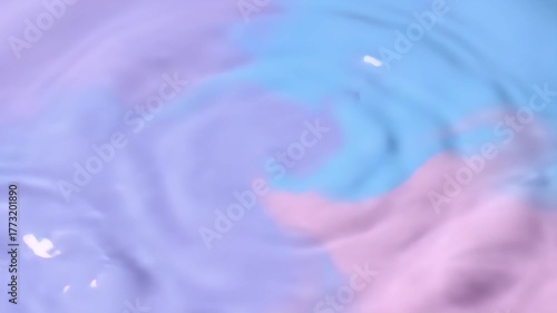 Gentle Water Drop Creating Ripples on a Pastel Surface.