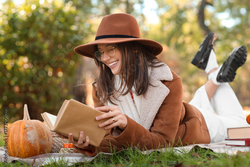 Happy young woman with book...