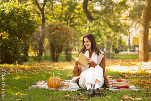 Happy young woman with book...