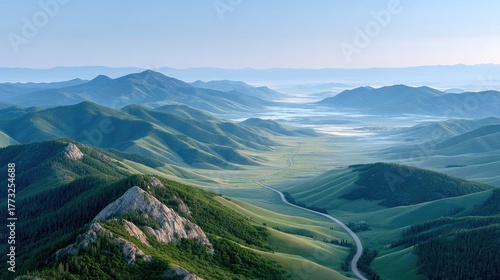 Vast Green Rolling Hills Under a Clear Blue Sky With Wisps of Fog in the Valleys at Sunrise
