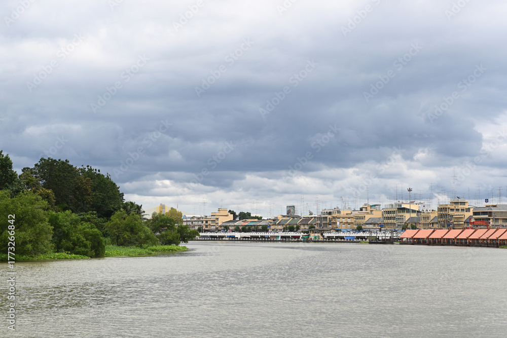 Naklejka premium A riverside community on a cloudy day in Thailand