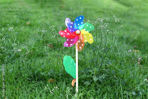 toy windmills on a background of green grass on a Sunny summer day
