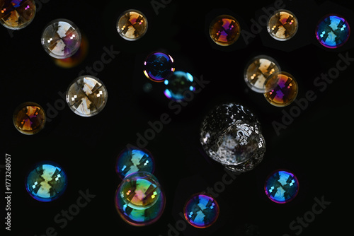 Beautiful Colorful Soap Bubbles Floating on Black Background.