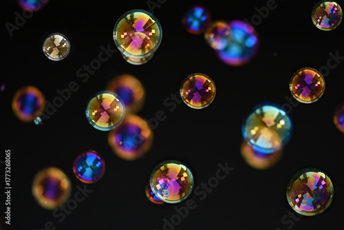 Beautiful Colorful Soap Bubbles Floating on Black Background.