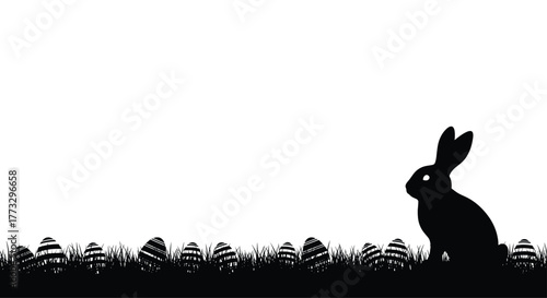 A black silhouette of an Easter bunny sitting in grass among patterned Easter eggs, isolated on a white background, symbolizing springtime holidays.