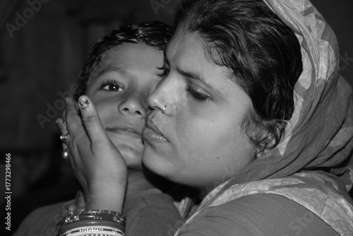 Happy indian mother wearing sari with son at home