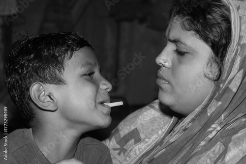 Happy indian mother wearing sari with son at home