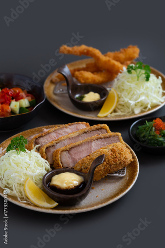 Japanese deep fried pork or tonkatsu set with Japanese deep fried shrimp on grey background.
