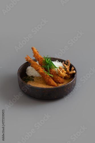 Curry rice with Japanese deep fried shrimp on grey background.