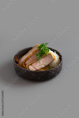 Tonkatsu or Crispy fried pork with Curry rice on grey background.