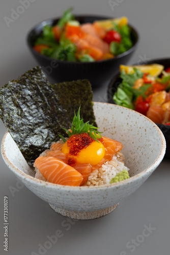 Salmon Donburi Japanese food style with Salmon salad on grey background.