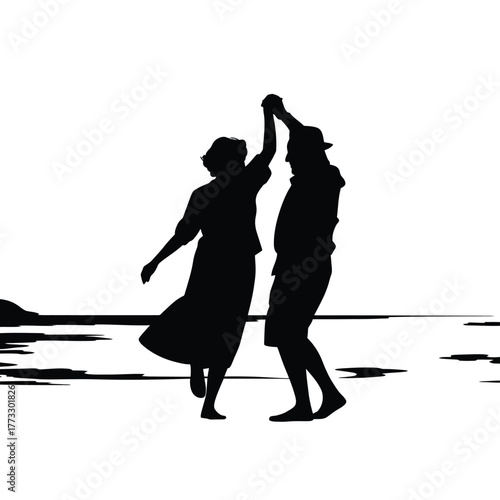 Silhouette of a happy couple dancing on a beach at sunset