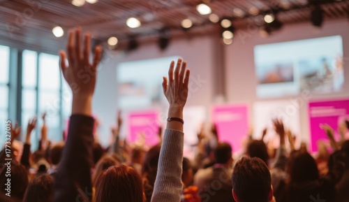 Audience Members Raising Hands During Conference or Seminar in Large Indoor Venue