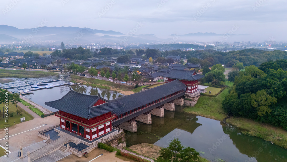 Naklejka premium morning light South Korea - October 25, 2025: Aerial and spring view of tiled house of Woljeonggyo Bridge on Namcheon Stream at Kyochon village