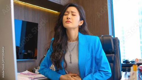Businesswoman’s Predicament: A businesswoman, facing an office crisis, struggles with a stomach ache, her face contorted in pain amidst the chaos. 