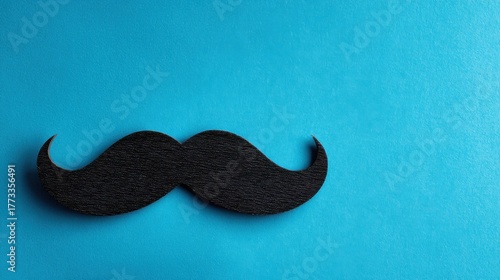 Close-up of a Black Mustache on Bright Blue for Movember Theme