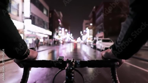 Nighttime Bicycle Ride Through City Streets with Lights and Reflections.
