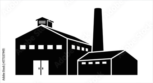 Industrial factory building with tall chimney